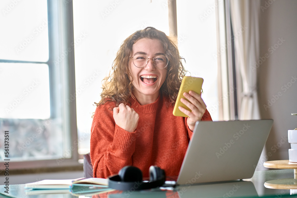 Woman excited at a computer about getting a new job